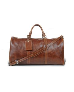 Front view of the carry on personalized leather duffle bag showing the strap across the front and a luggage tag. All items are in a British Tan Florentine